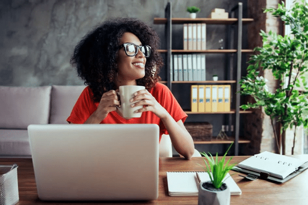 Woman smiling while working from home on her laptop
