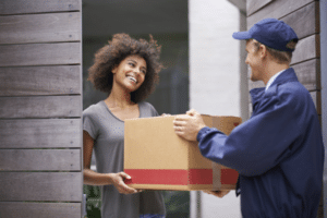 Smiling woman accepts holiday parcel